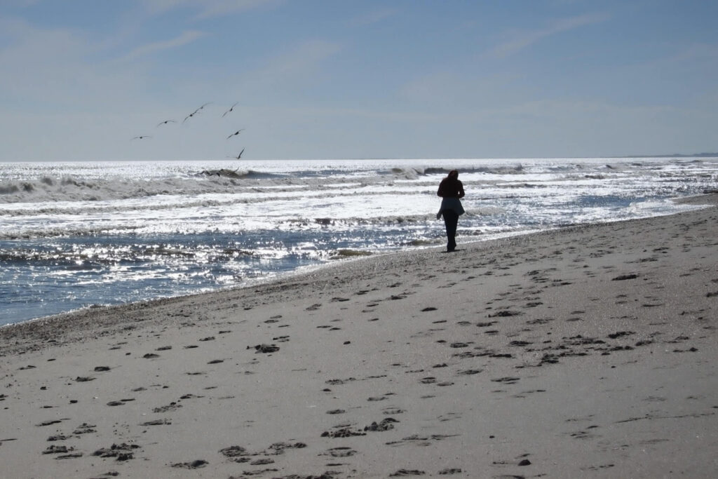 A person enjoying Sustainable Travel on a beach.